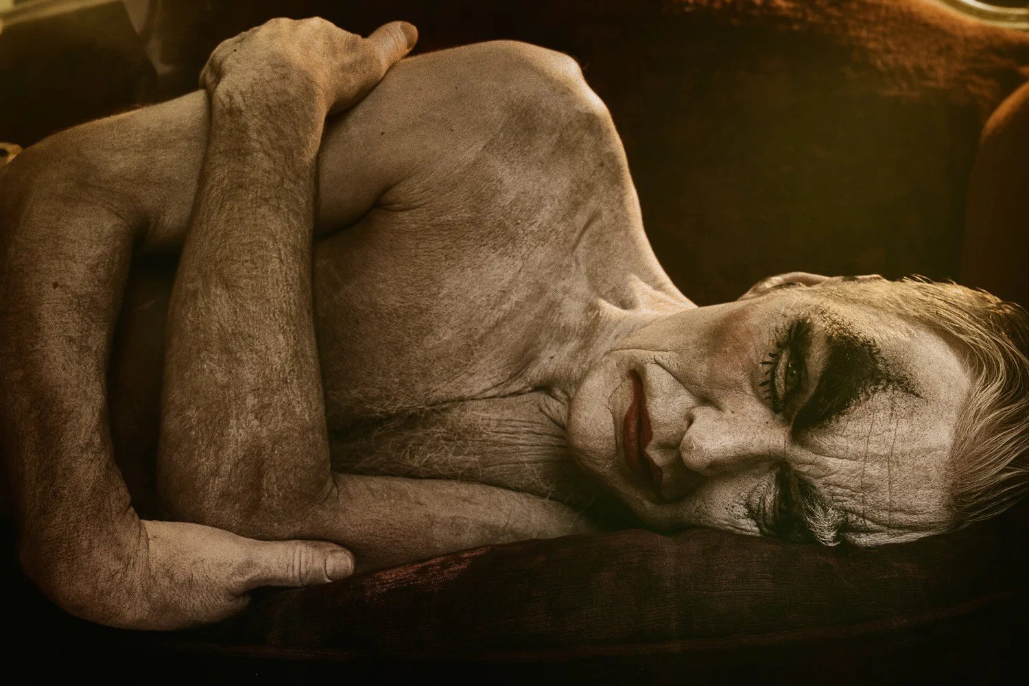 Expressive portrait of a reclining figure with theatrical makeup, by Eolo Perfido